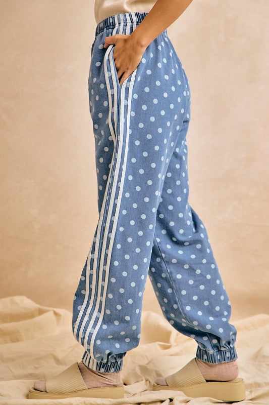 Blue polka dot pants with white stripes on a beige background
