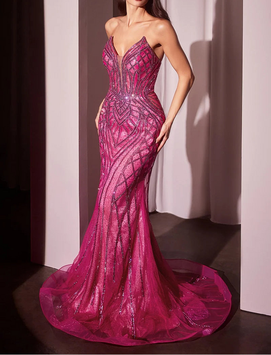 Woman wearing a pink evening gown with intricate detailing against a neutral background