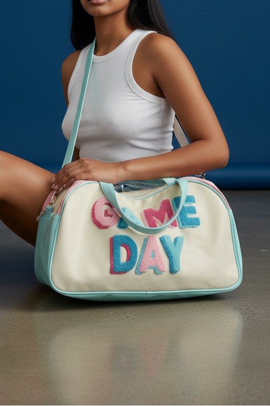 Woman holding a bag with 'Game Day' text against a blue background