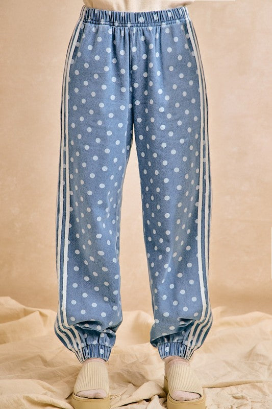 Blue polka dot pants with white stripes on a beige background