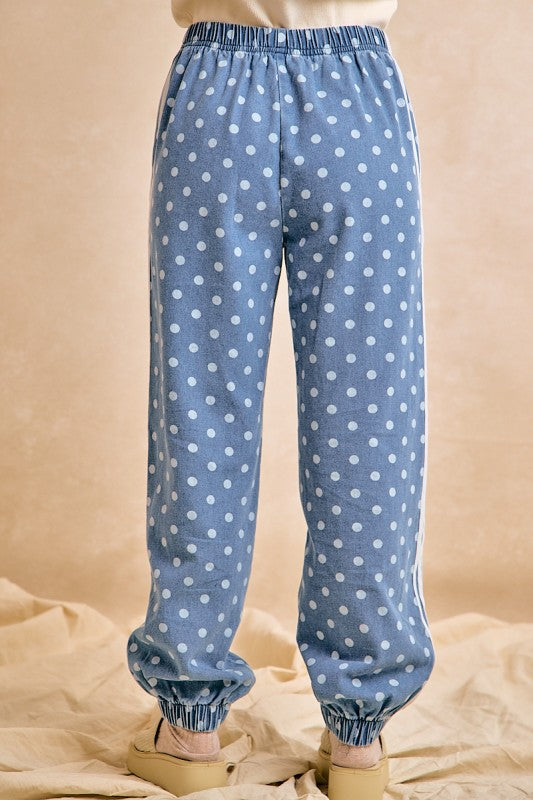 Blue polka dot pants on a beige background
