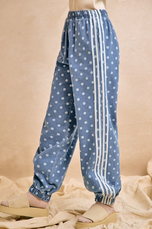 Blue polka dot pants with white stripes on a beige background