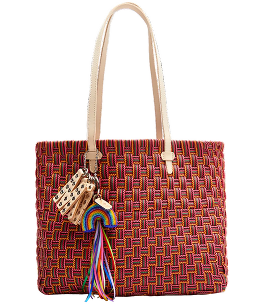 Woven handbag with rainbow charm on a white background