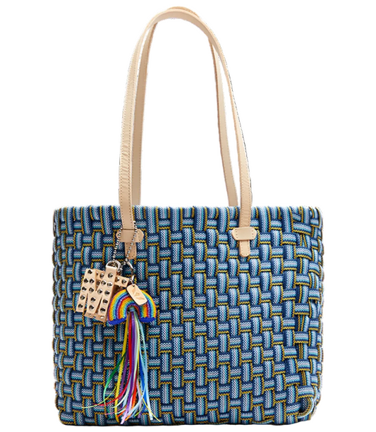Woven handbag with a colorful tassel on a white background