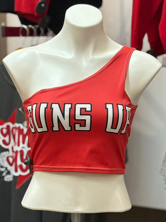 Red crop top with 'Guns Up' text on a mannequin in a store setting.
